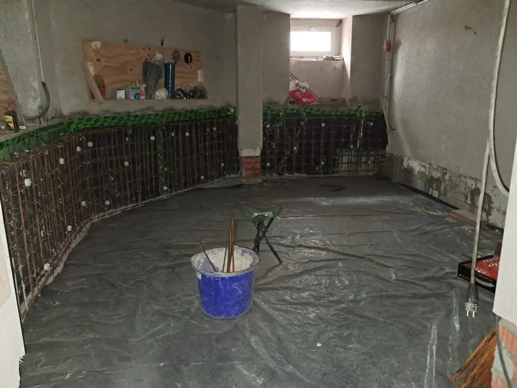 Boden und Wände wurden mit der wasserdichten Folie gesichert, die Errichtung der Auflastwanne aus Stahlbeton ist an den Wänden vorbereitet.